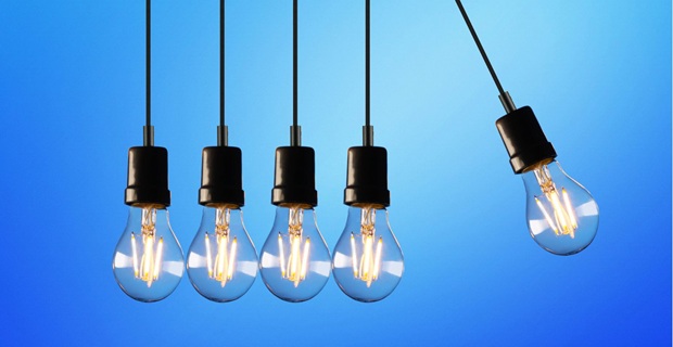 Cinque lampadine a filamento LED a bulbo stile Edison, dal design vintage, su sfondo azzurro.